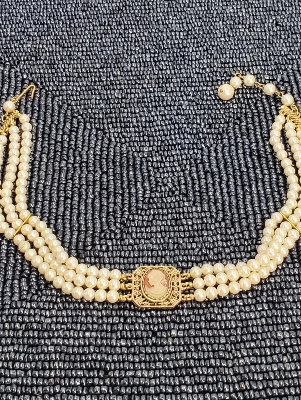 Vintage-style 3-strand pearl choker necklace with a prominent cameo centerpiece